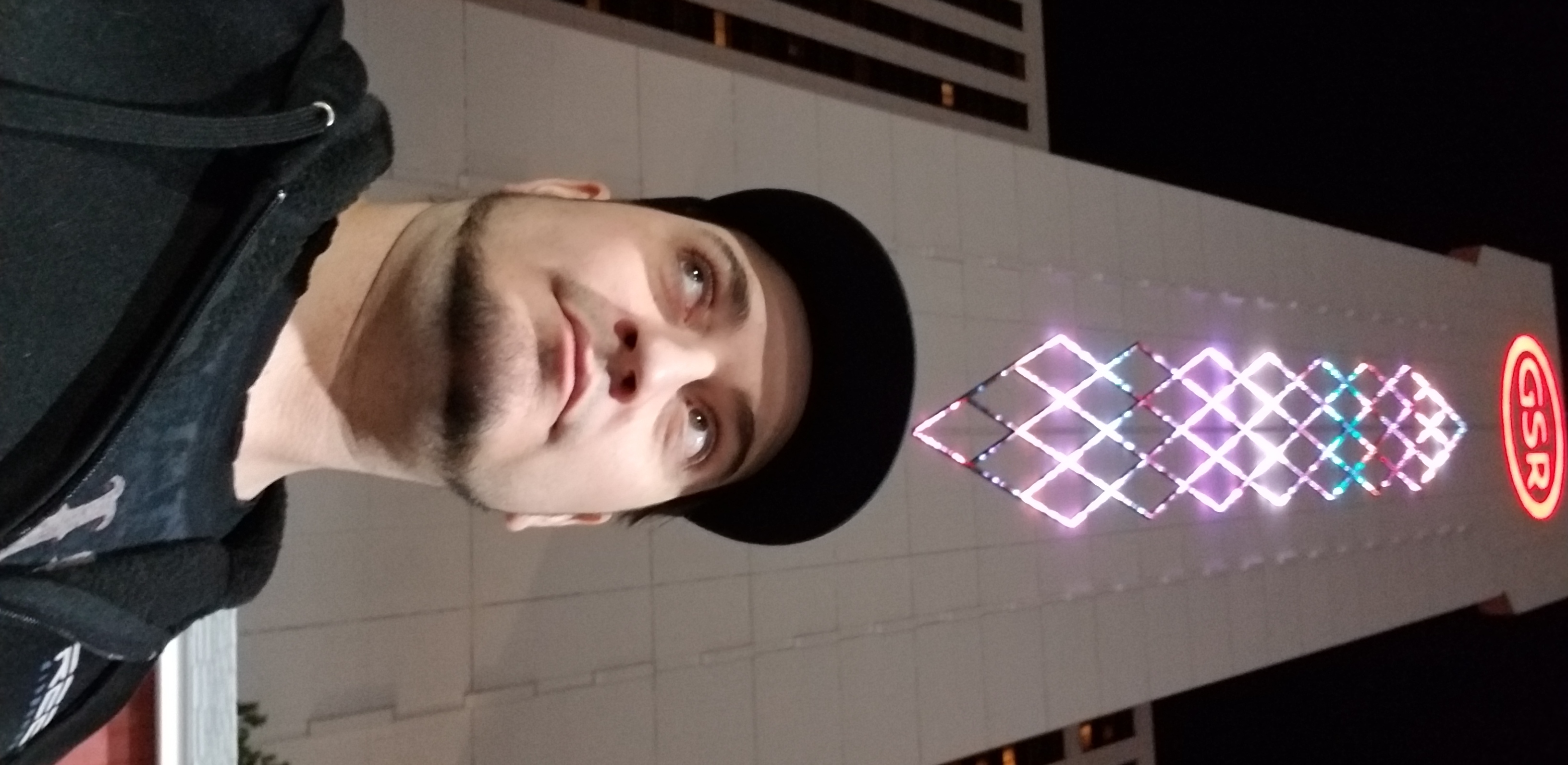 Kronik at night in front of GSR resort lights in Reno