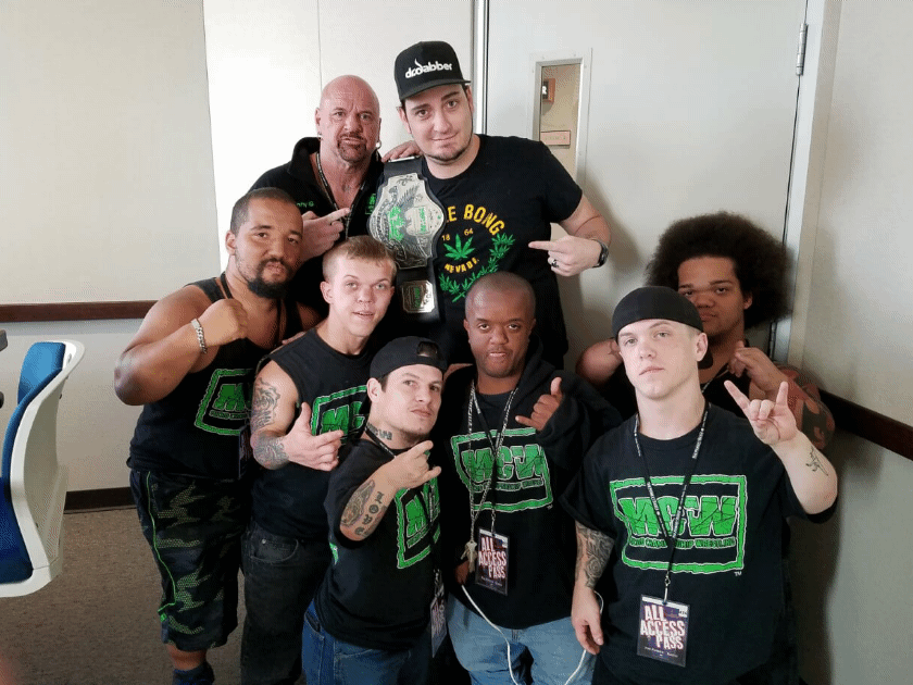 Group photo with wrestling talent and MLW shirts at event